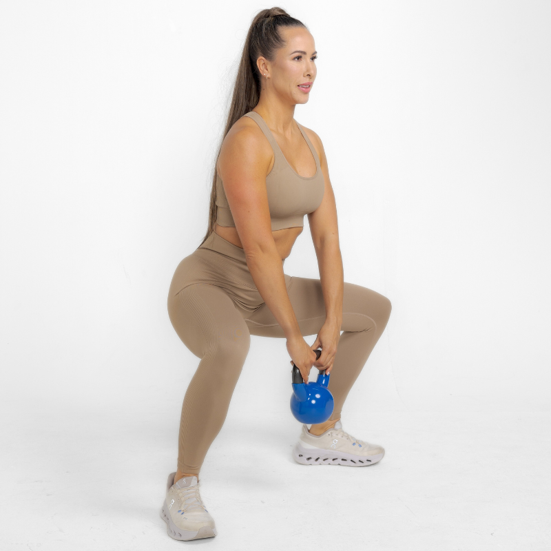 Athara MaxSculpt Leggings in Desert Tan – Model Squatting for Stretch Test