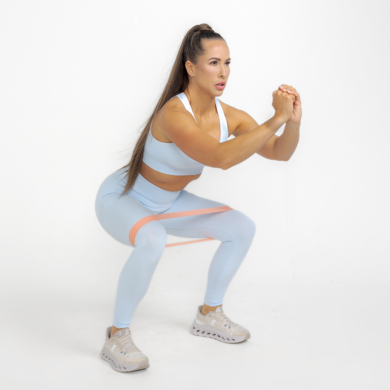 Athara MaxSculpt Leggings in Glacier Blue – Model Squatting for Stretch Test