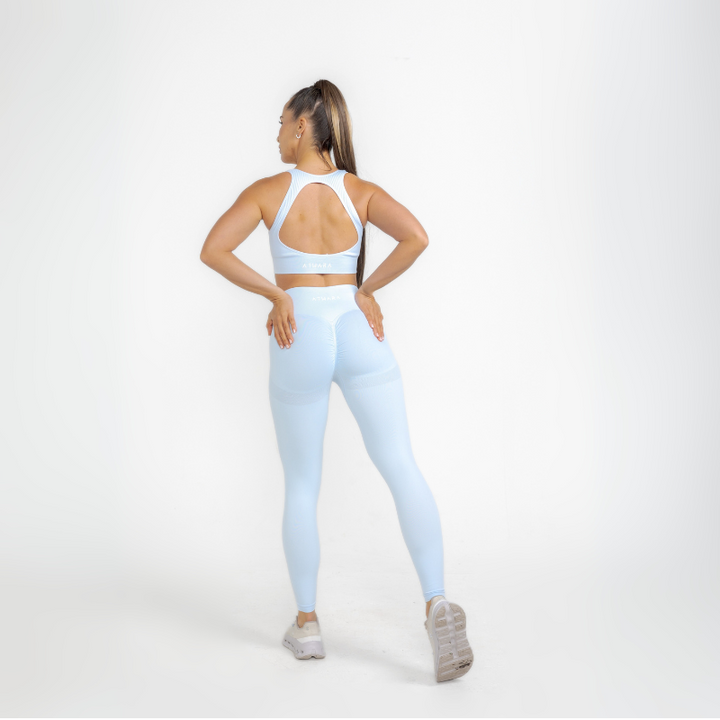 Athara MaxSculpt OpenBack Sports Bra in Glacier Blue – Full-Length Angle View on Model